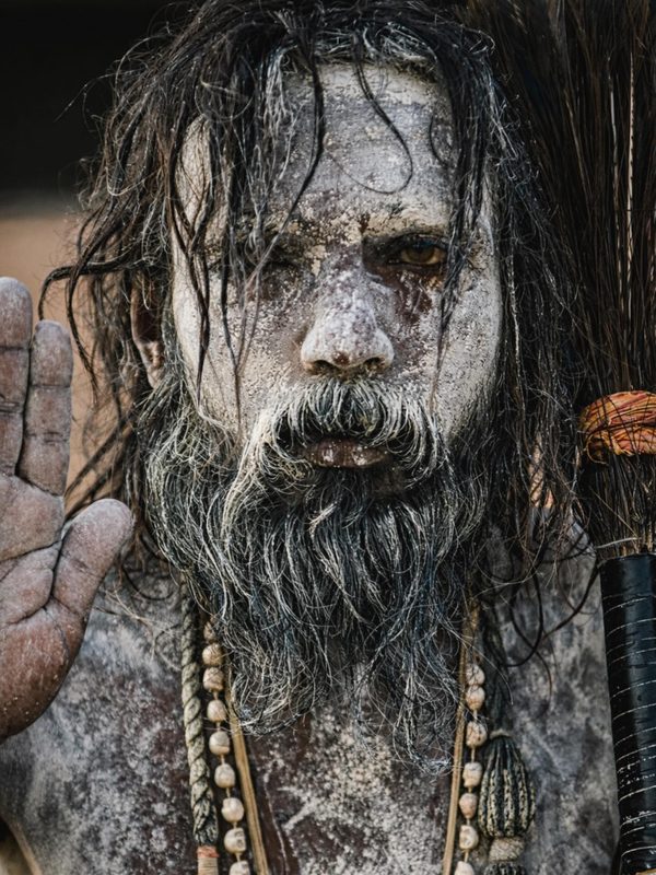 An ash-covered holy man on the banks of the Ganges staring straight into the lens, unflinching.