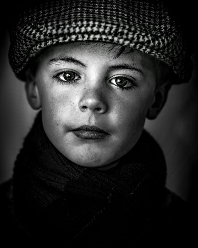 Portrait of an Irish boy with striking eyes, the ocean and far-off journeys behind his gaze.