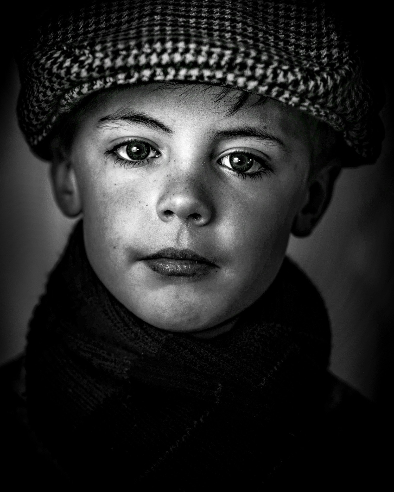 Portrait of an Irish boy with striking eyes, the ocean and far-off journeys behind his gaze.